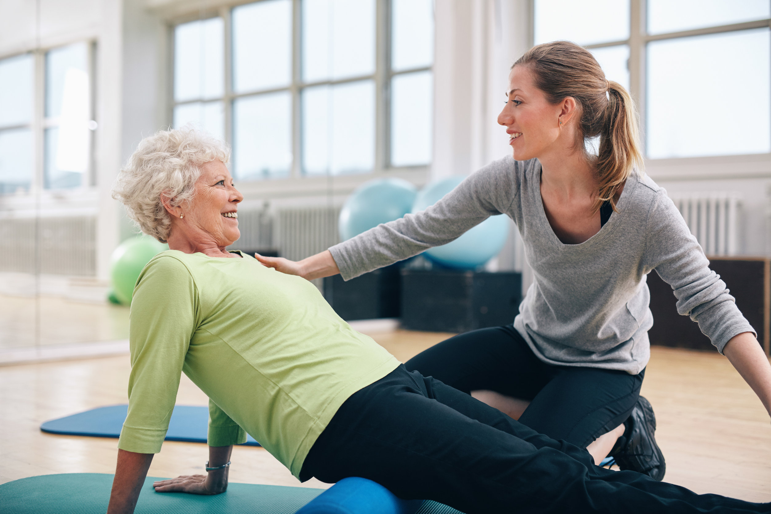 Physical therapist working with a senior woman at rehab